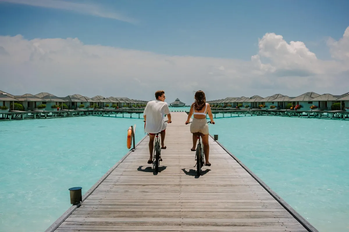Couple enjoying a floating breakfast at a Maldives resort