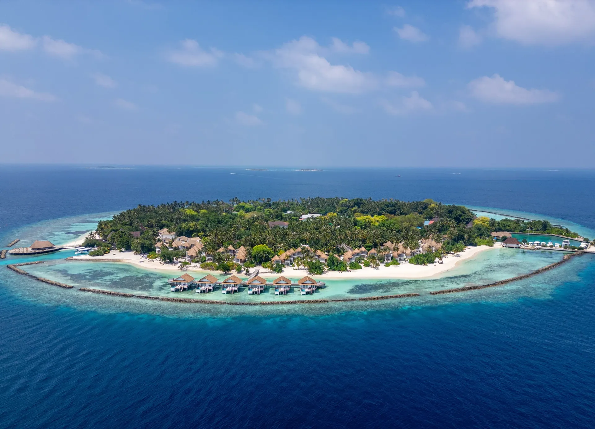 Aerial view of a resort island ringed by its reef